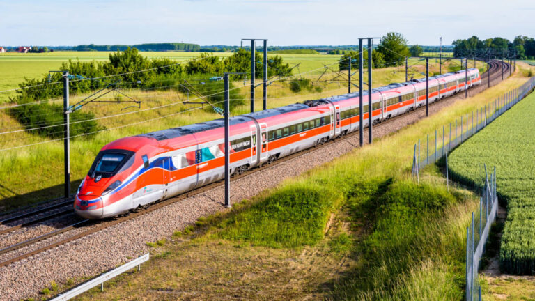 Aerial view of a red train on the track in France