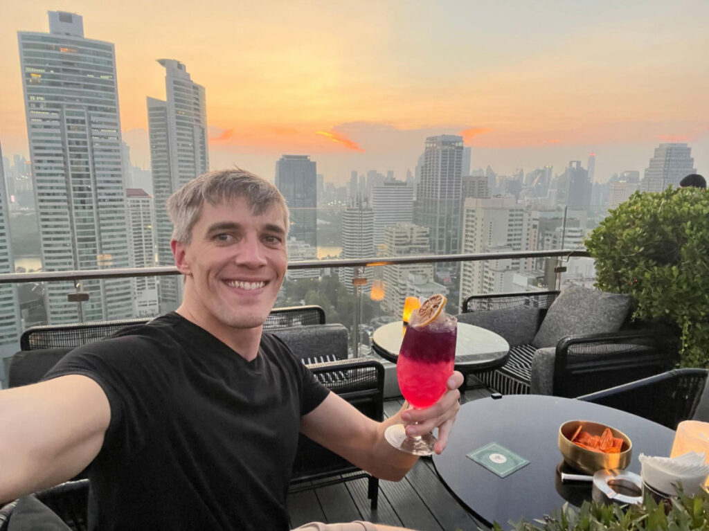 The author, Nate Hake holding his drink at the ABar Rooftop