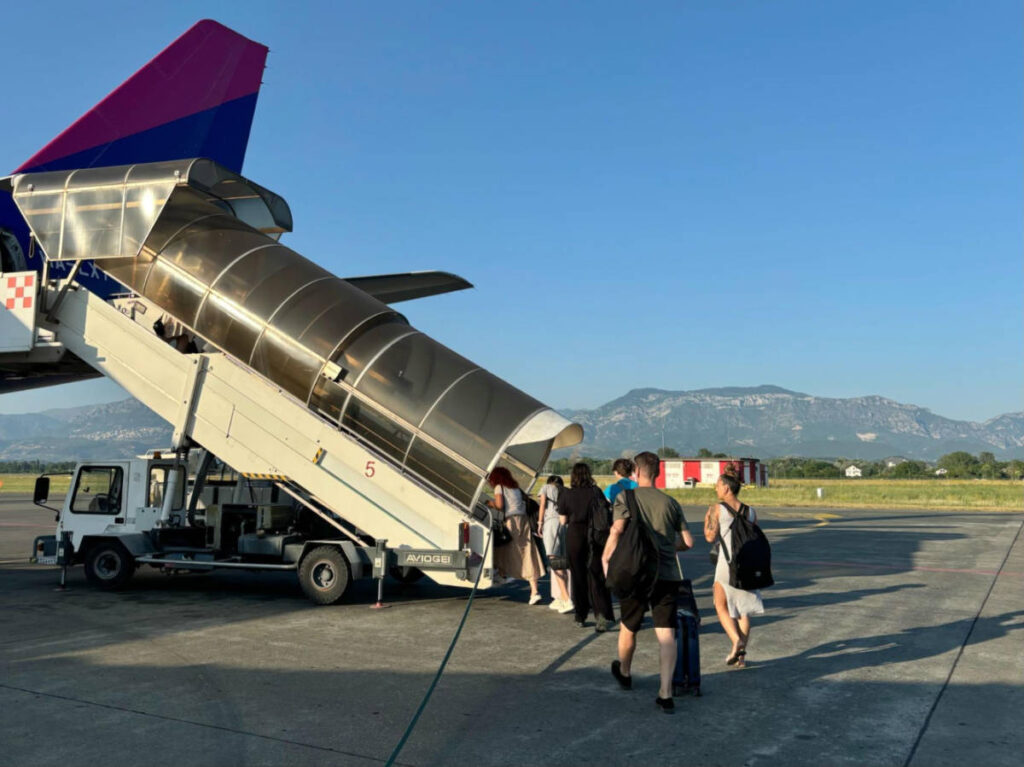 People walking up the air stairs at Tirana International Airport