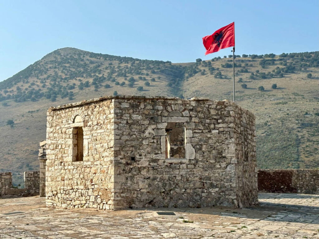View of the Albanian flag in Porto Palermo Castle