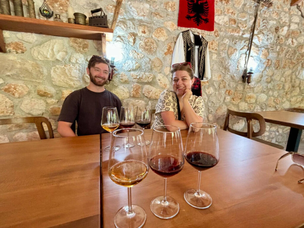 The author's friends with glasses of local wines made from Albanian grapes