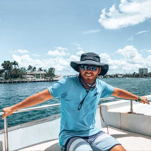 Andrew Bloem smiling for a photo while on a boat