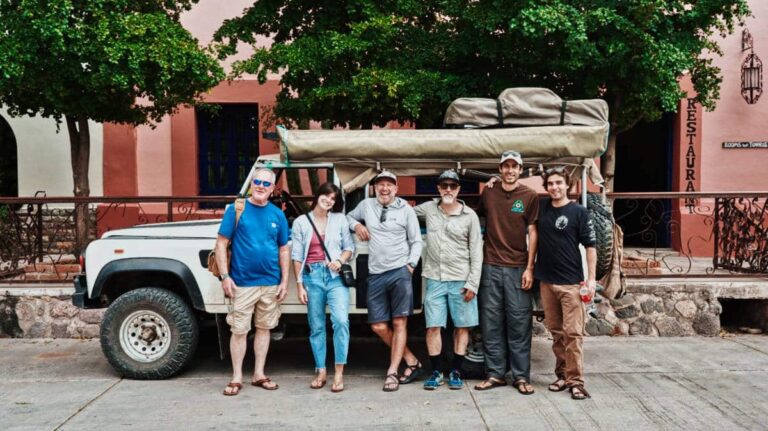 The author Betty Hurd with the group, posing for a photo in front of the car for a road trip