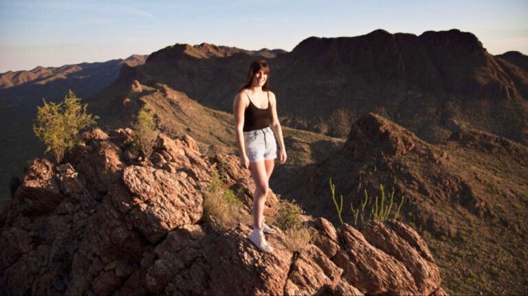 The author Betty Hurd, posing at the peak of a mountain in Tucson.