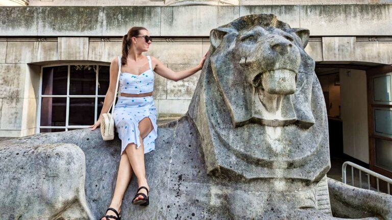 Author Brooke sitting on the Stone lion outside the British Museum