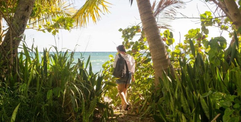 Author Vanessa walking on a path going to the beach