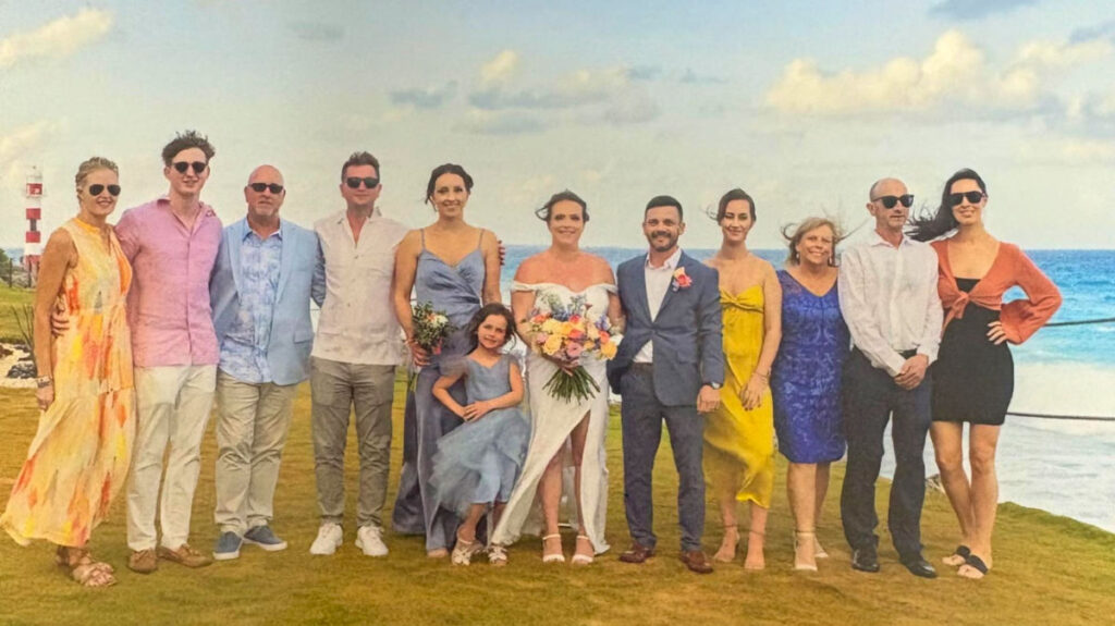 Author Niamh and family taking a picture at the water’s edge of Hyatt Ziva Cancun
