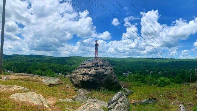 The author, Niamh Hayes standing on top of a rock at Harriman State Park