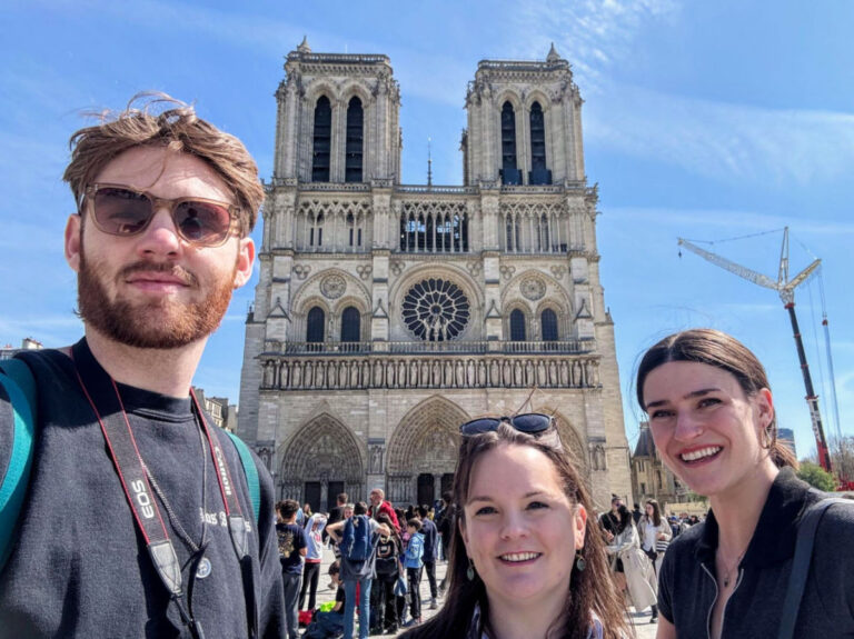 Author Rachel with Betty and Michael pose for a selfie in front of Notre-Dame Cathedral of Paris