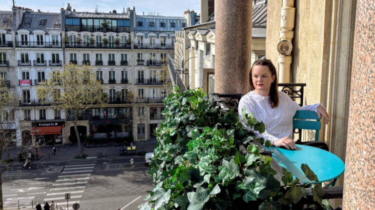 Author Rachel Kapelke-Dale sitting on a balcony of Solly Hôtel