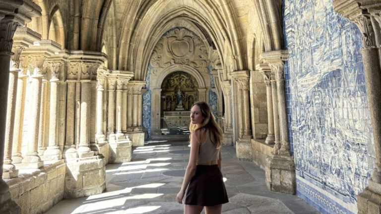 Author Sky walks through the cloister of Porto Cathedral in Portugal