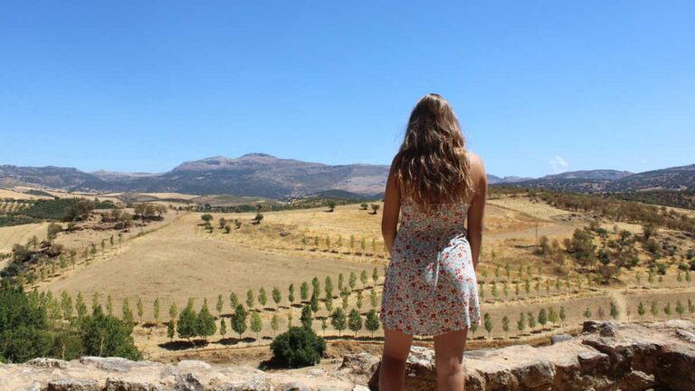The author Sky Ariella admiring the overlooking view of Ronda