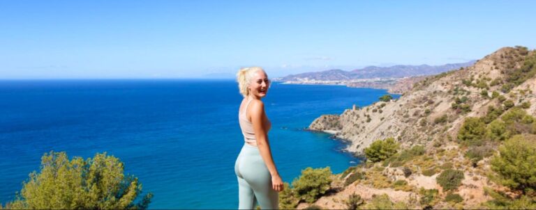 Author Sky Ariella under the clear blue sky with the blue water on her background