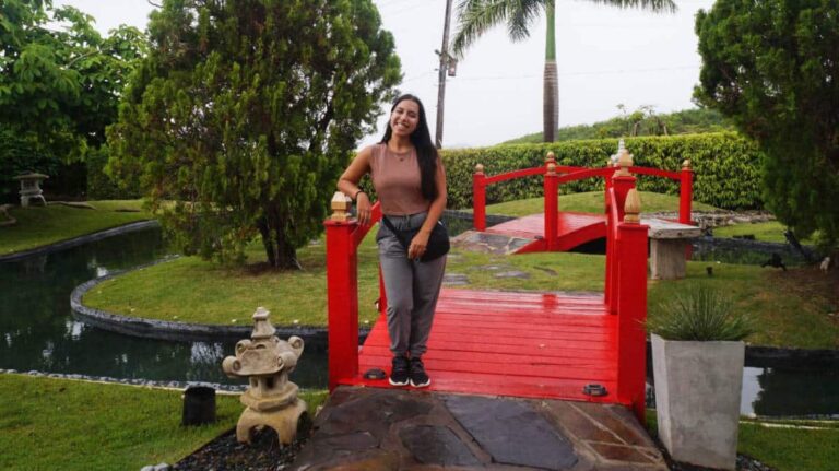 The author, Vanessa Ramos standing in a red bridge at the Japanese Garden in Ponce