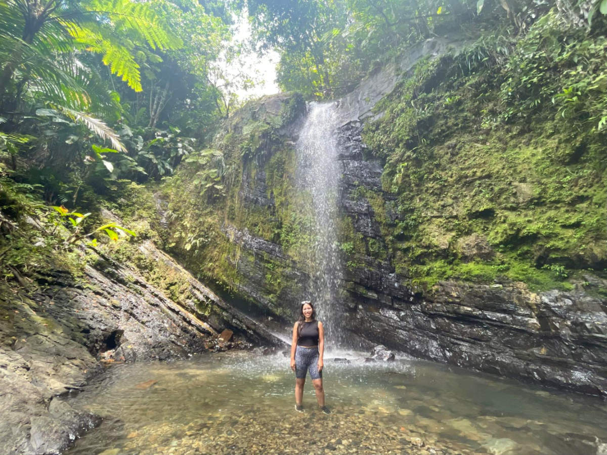 Author Vanessa standing at the bottom of El Yuque waterfall