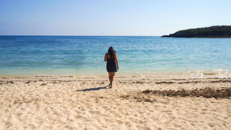 Author Vanessa walking on a sandy beach in Vieques