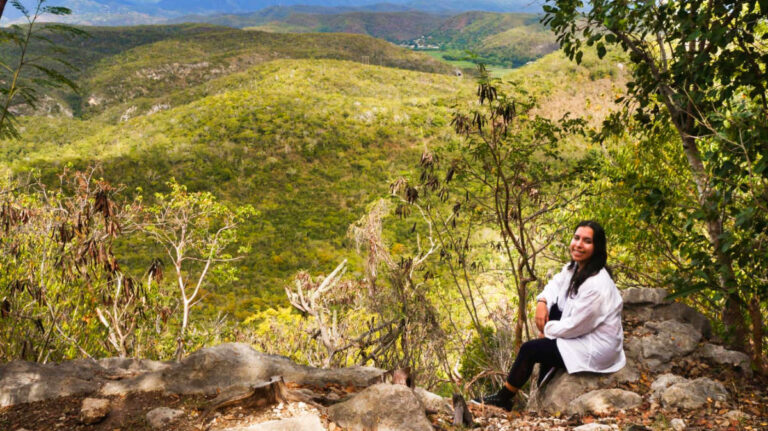 Author Vanessa resting on a rock after a hike