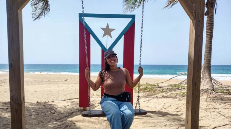 Author Vanessa Ramos, on a swing at the beach
