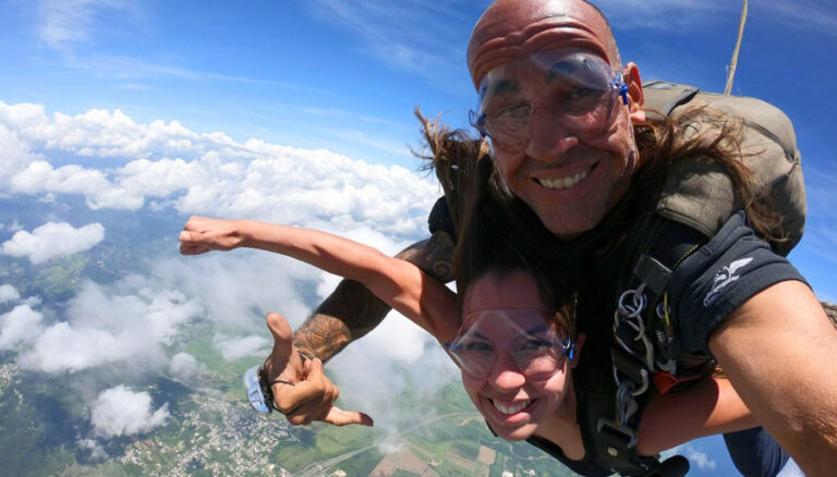 View of the author Vanessa skydiving with a man in Puerto Rico
