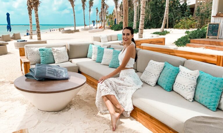 Clara sitting on a couch in Banyan Tree Mayakoba