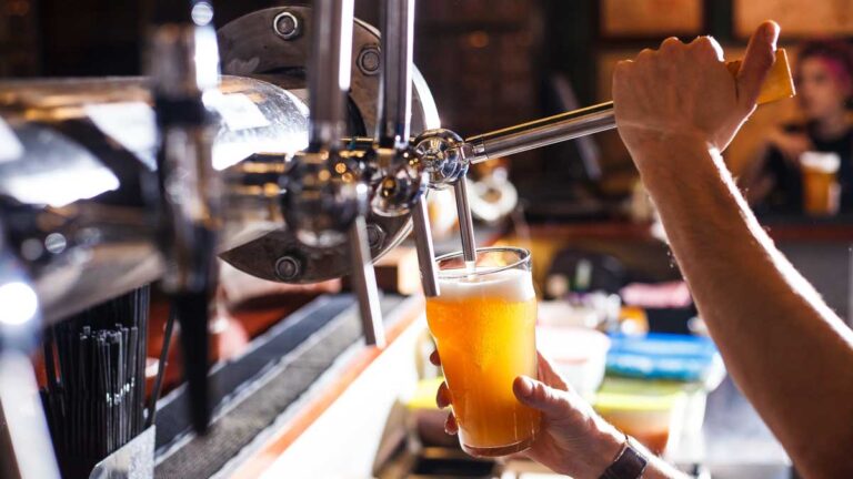 A bartender getting a beer on a beer tap