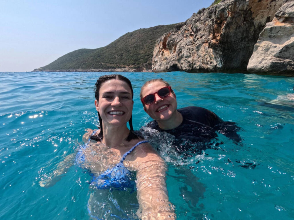 The author Betty Hurd and her friend swimming in Gjipe Beach