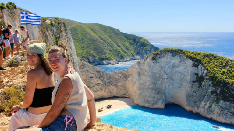 The author Betty Hurd and other tourists enjoying the overlooking view at Navagio Beach