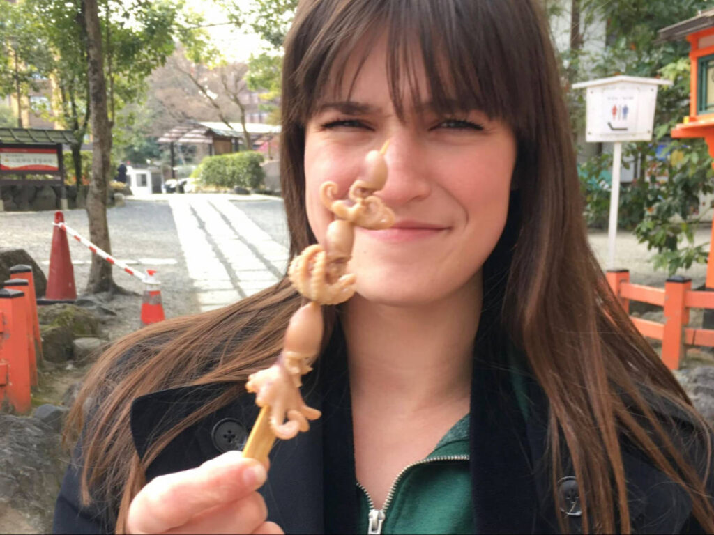 The author, Betty Hurd holding a squid skewer