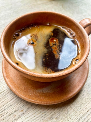 A cup of frothy black americano from Pophams