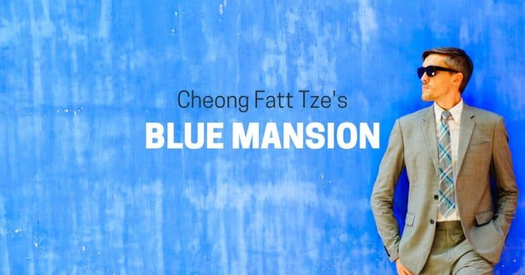 Author Nate posing for a photo in a blue wall background