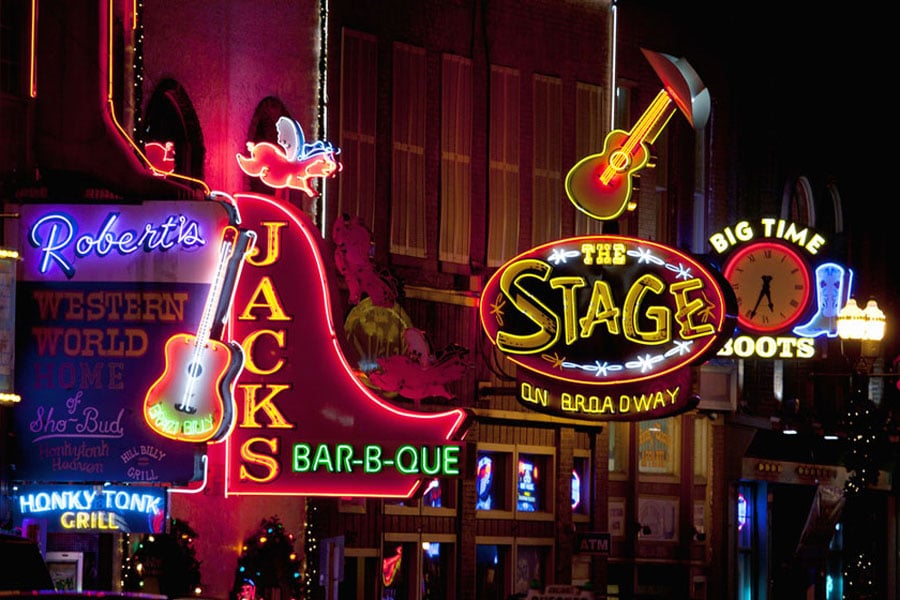 View of neon store signs along the Broadway Honky Tonks