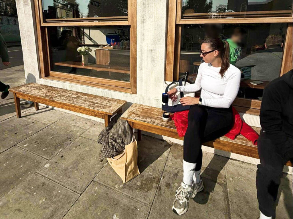 The author Brooke Horrobin, enjoying a cup of Americano in the sun outside the Riffs