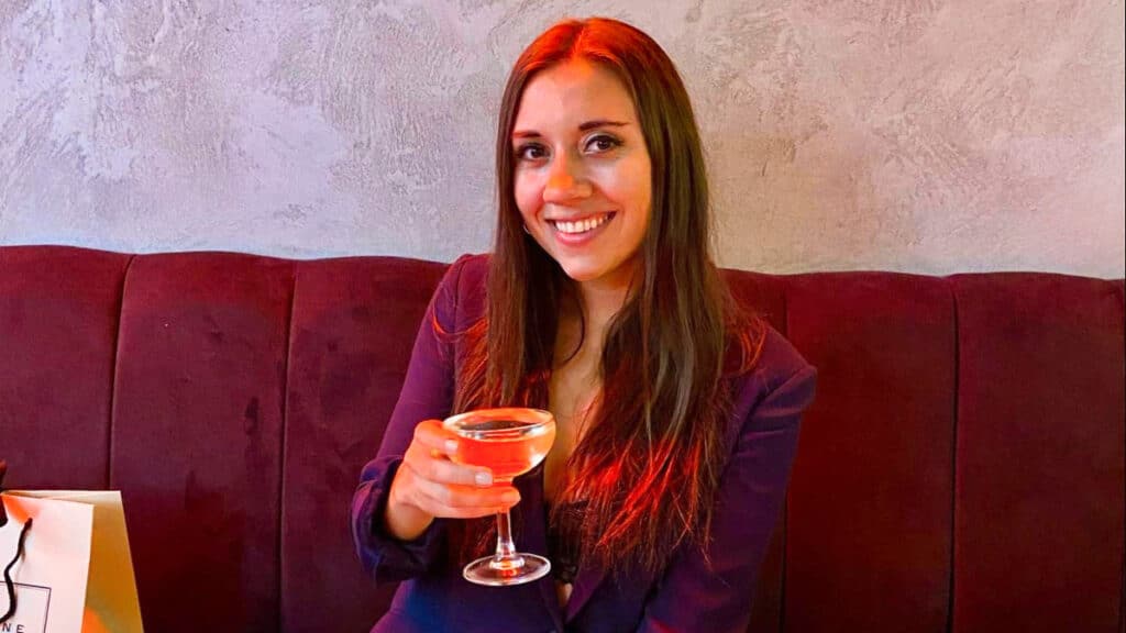 The author Brooke Horrobin, posing with a glass of prosecco at London Bridge Grind
