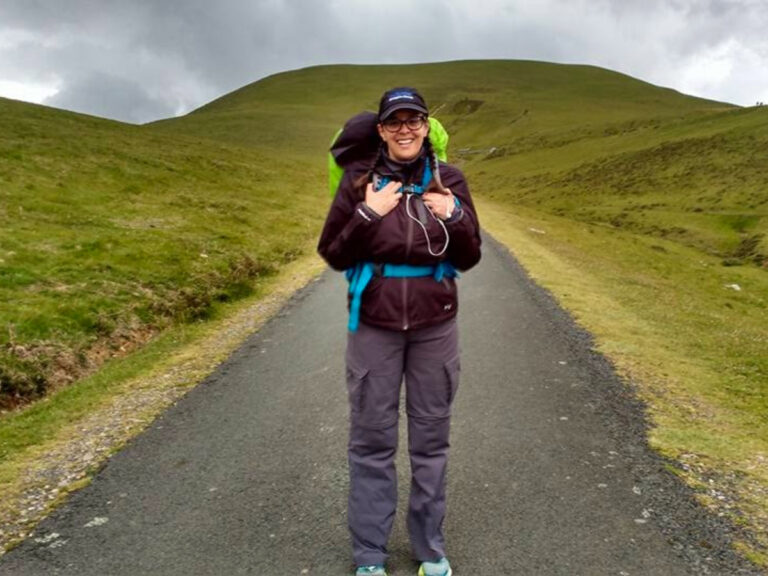 Author Catherine Driver with a backpack standing on a road, starting out her Camino in the Pyrenees