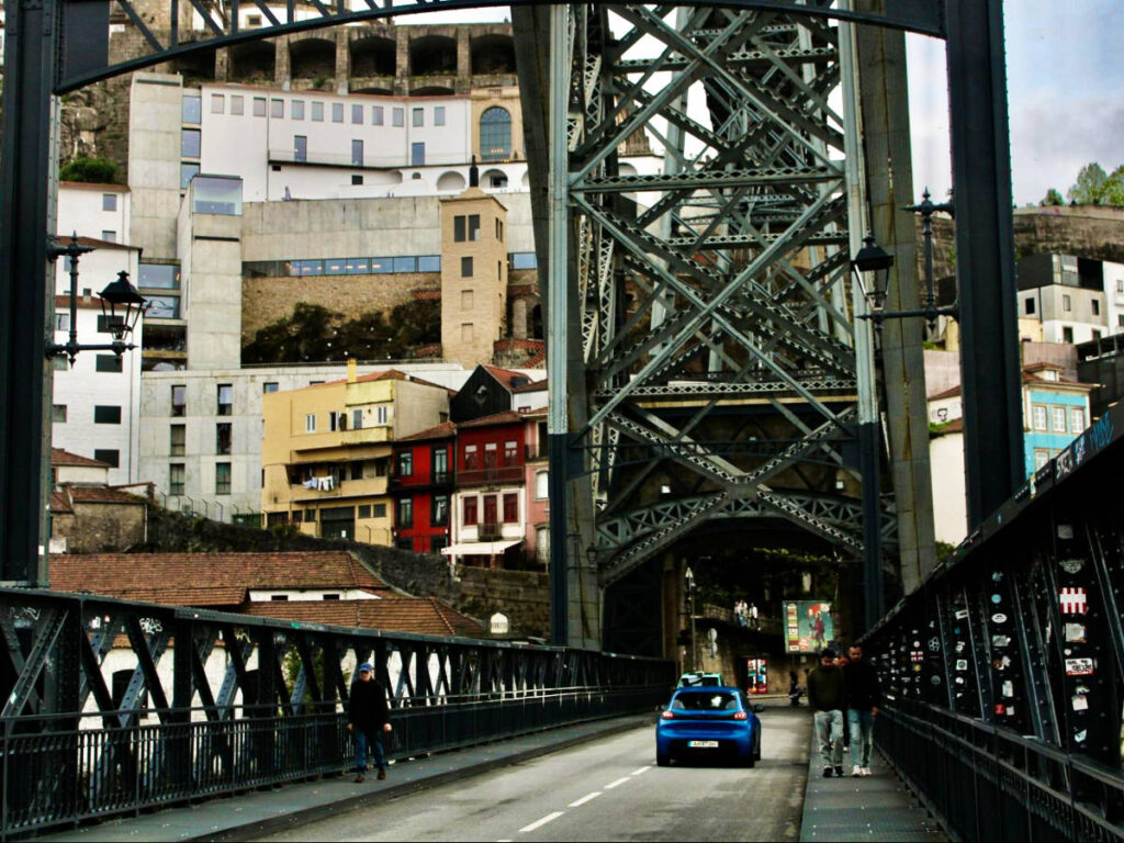 A car driving over the Dom Luis Bridge