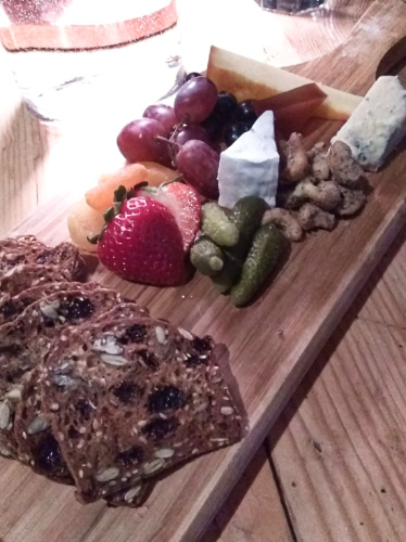 The cheese board with fruits, nuts, and variety of cheeses