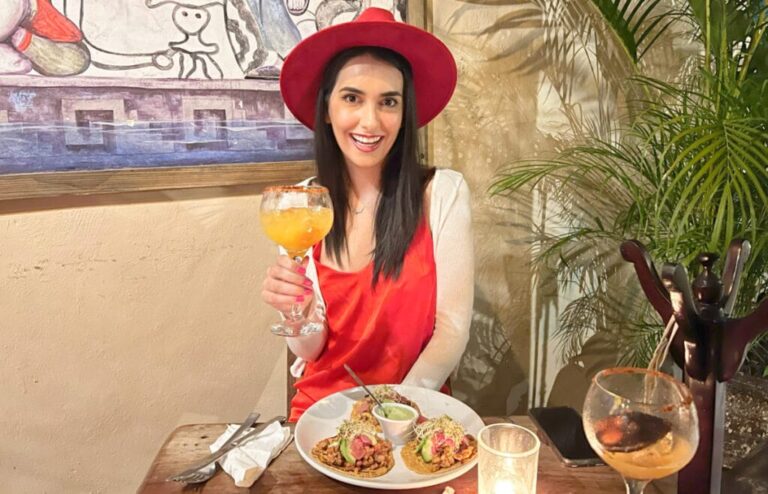 Travel Lemming Writer Clara, posing for a photo while holding a glass of drink at Casa Conato