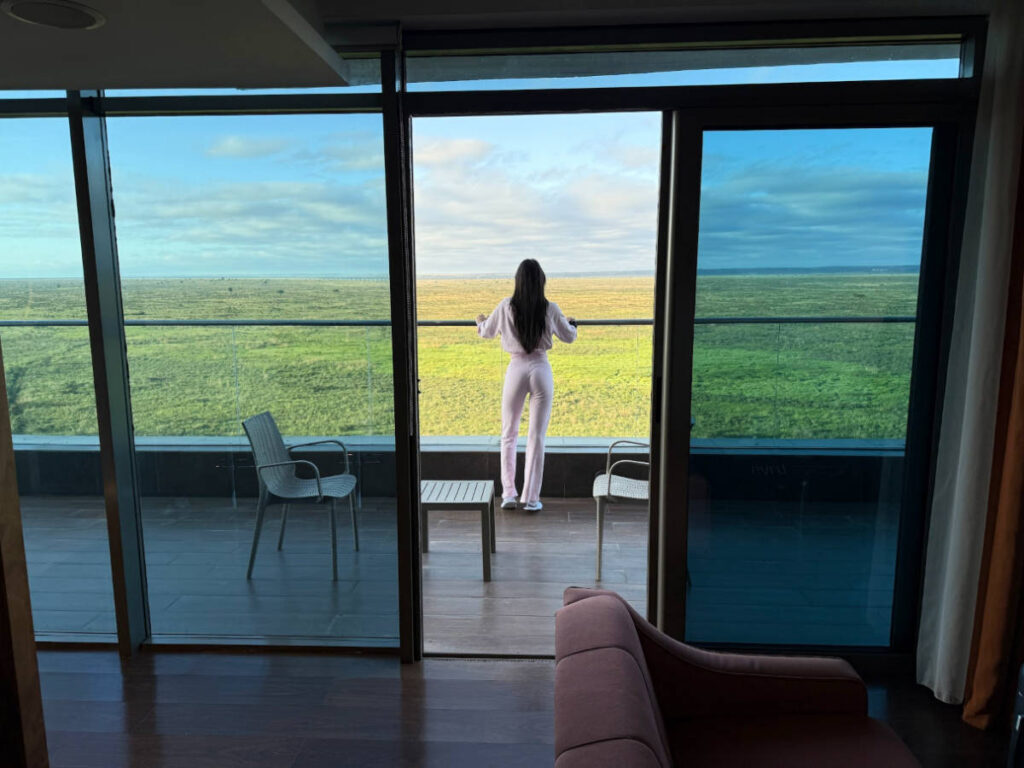 Travel Lemming writer Clara Kesseler, enjoying the overlooking view of the greenery from her room in Emara Ole-Sereni