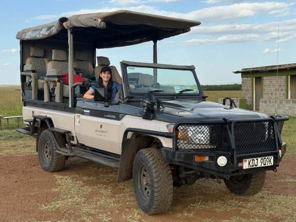 Travel Lemming writer Clara Kesseler, smiling for a photo while sitting on the safari vehicle