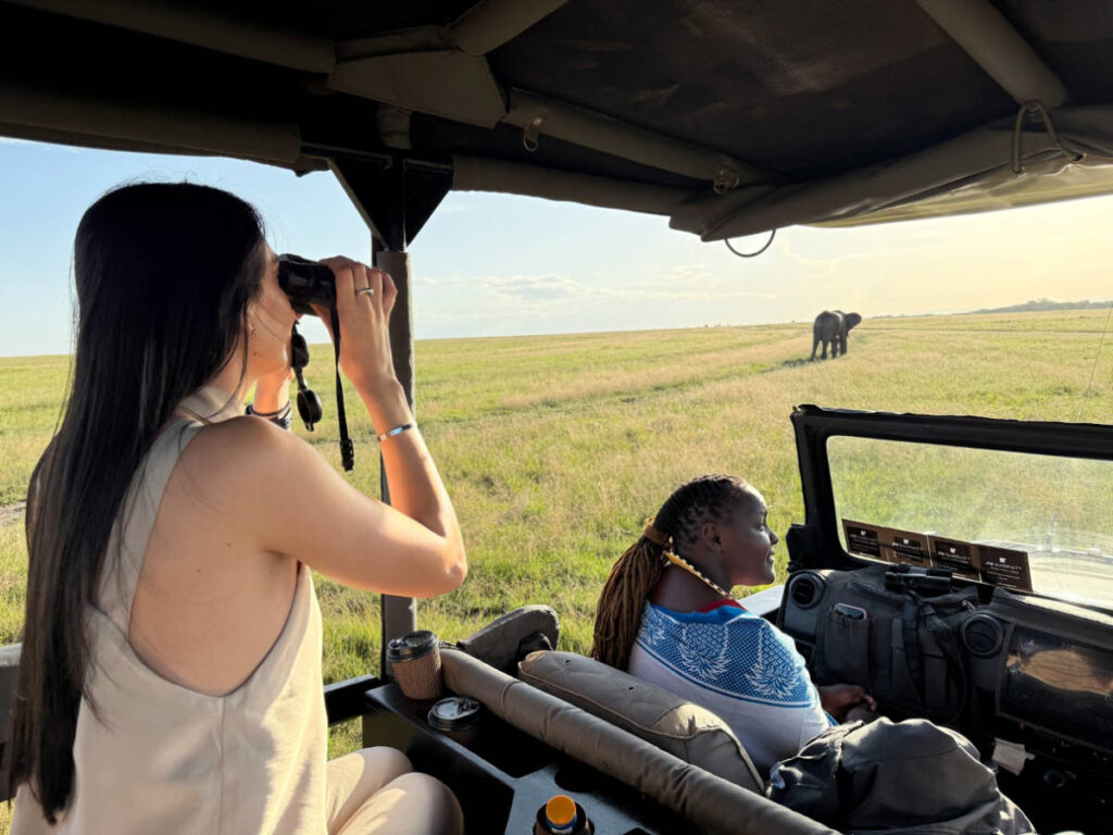 Travel Lemming writer Clara Kesseler, watching the elephant through her binoculars