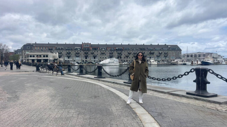 The author, Claudicet Pena posing for a photo with the harbor in the background