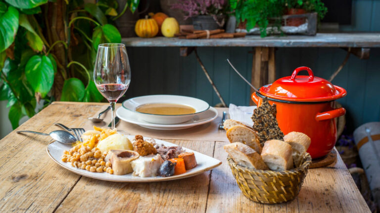 View of Cocido Madrileño and bread on a table in a restaurant