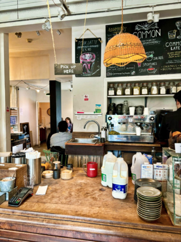 A barista preparing at the coffee counter of Common