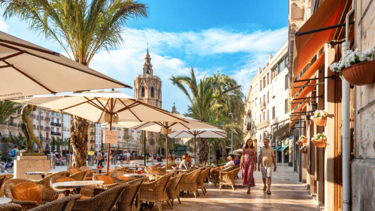 Panoramic view of the people walking and chilling at Plaza de la Virgen in Ciutat Vella