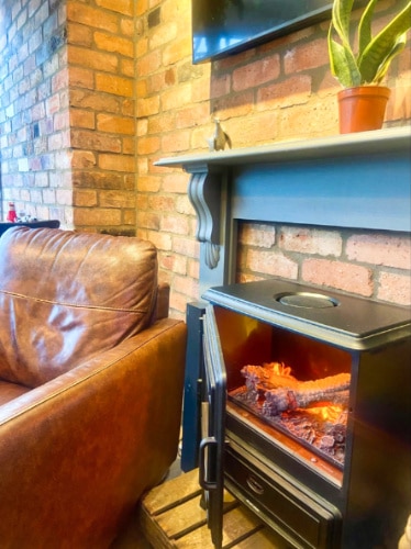 A cozy fireplace near the seating area at Carter’s