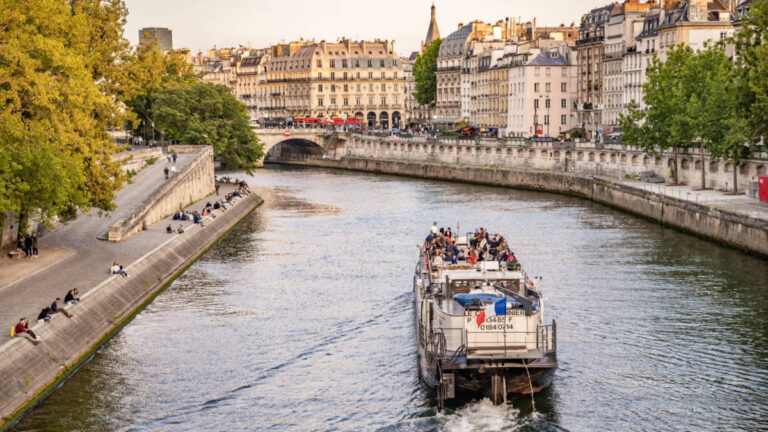 A cruise sailing along the Seine River in Paris