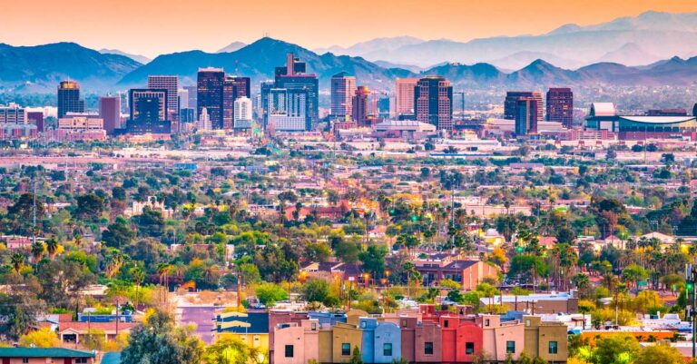 Overlooking view of Downtown Phoenix skyline at sunset with mountains in background