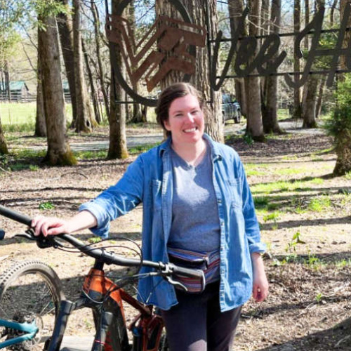 Elizabeth Demolat holding a bicycle in Vee Hollow