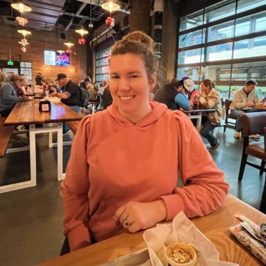 The author smiling for a photo inside the Assembly Food Hall