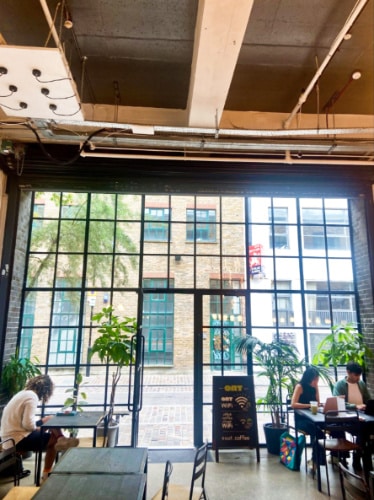 View of the floor to ceiling glass entrance door of OAT Shoreditch